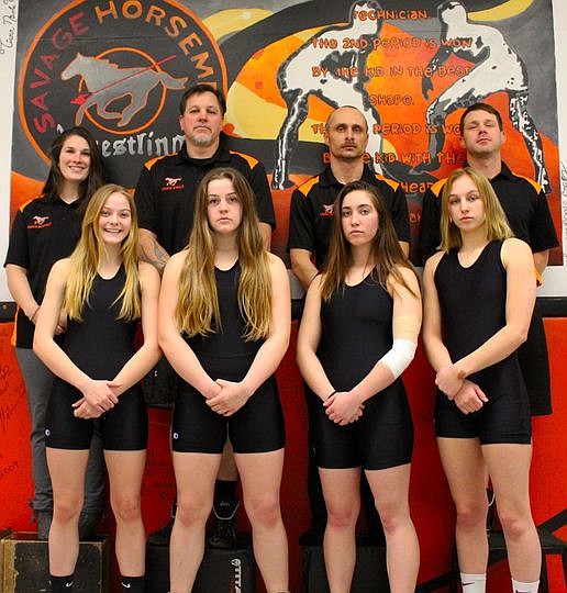 The Plains-Hot Springs girls wrestling will be part of history this weekend when it competes at the first Montana State Girls Championship this weekend. From left, front row, are Olivia Easter, Lily MacDonald, Mykenzi Blood and Taylor Angle. From left, back row, are coach Keaton Bannout, coach Shane Angle, coach Jesse Jermyn and coach Cal Courville. (Photo courtesy Plains Wrestling)