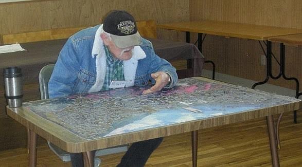 A Sanders County man works on a puzzle at the Plains Paradise Senior Center. The center is beginning a fundraising campaign to help keep it operational. Similar to many non-profits, the center has struggled with having enough money to achieve its mission. (Photo courtesy Plains Paradise Senior Center)