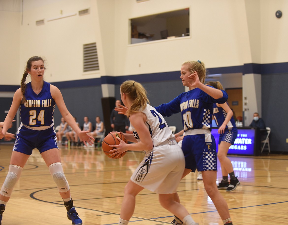 Thompson Falls basketball players Megan Baxter (24) and Faith Frields (20) put defensive pressure on Stillwater Christian School’s Marae Tintzman during their game last week. Baxter scored 30 points in her teams’ win last week. (Scott Shindledecker/Valley Press)