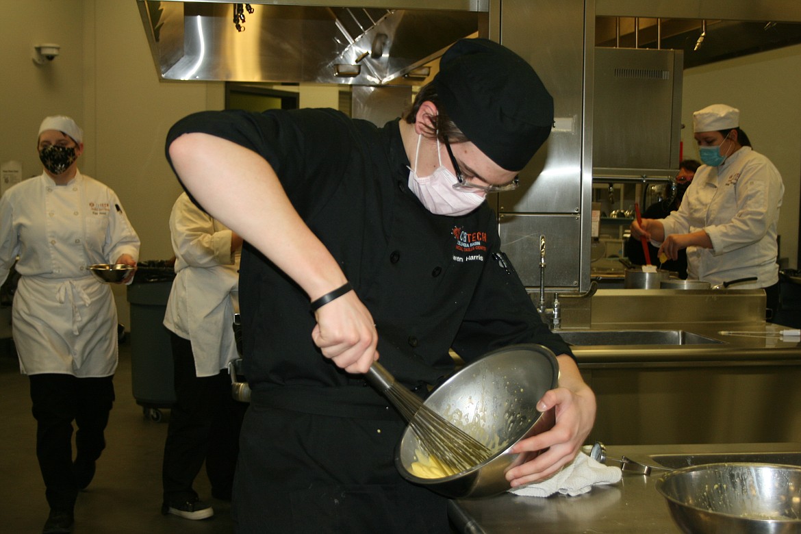 Owen Harris mixes the ingredients for chocolate mousse during culinary class at Columbia Basin Technical Skills Center Thursday.