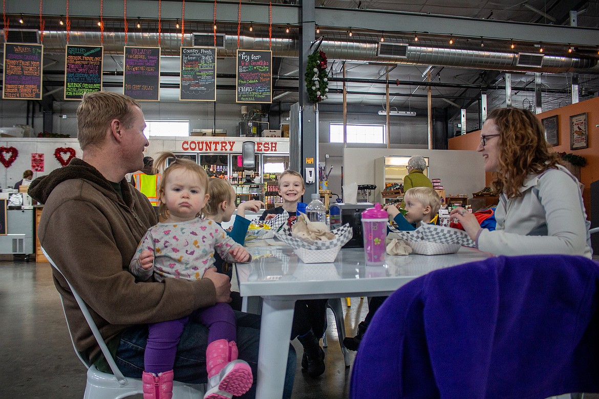 Left to right, Nicholas, Micah, Isaiah, Jonah and Holly Van Dyke sit down for lunch at the Quincy Public Market on Monday afternoon.