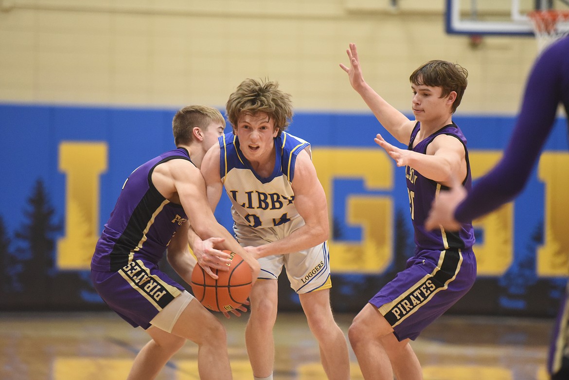 Libby senior Jay Beagle tries to break through Polson defenders during a Feb. 13 game. (Will Langhorne/The Western News)