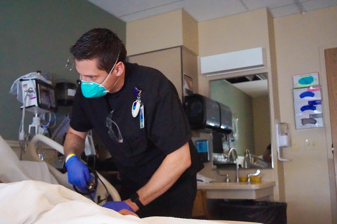 Samaritan nurse Danny Tracy checks on a patient on the Medical Surgical floor.