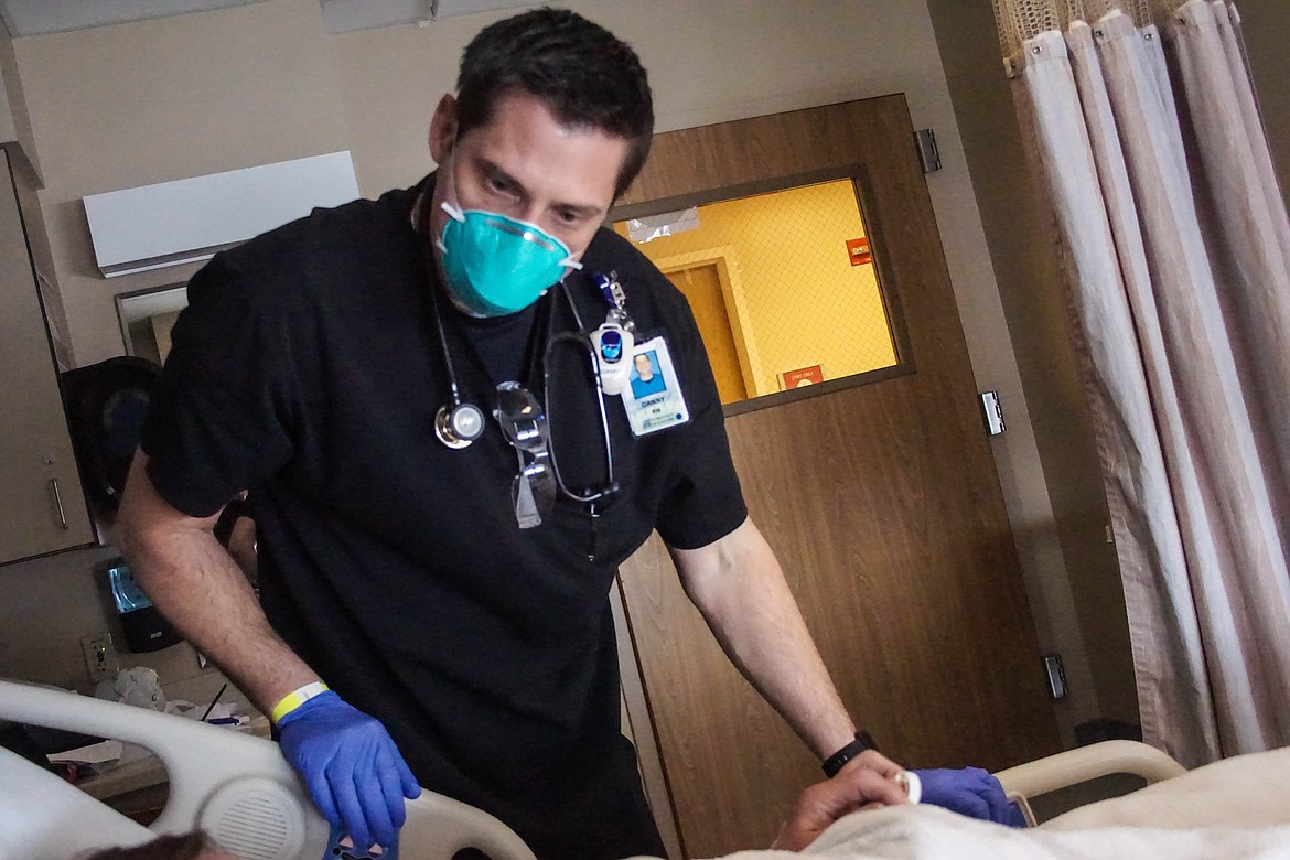 Samaritan nurse Danny Tracy checks on a patient on the Medical Surgical floor.