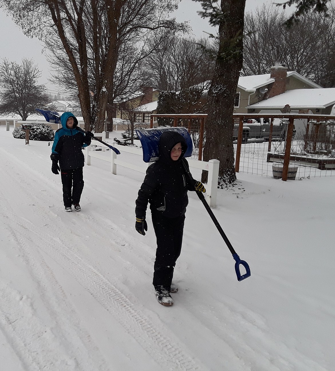 The McFadden brothers — 12-year-old Marcus (left) and nine-year-old Shane — head home after a morning shoveling snow. The Presidents' Day holiday kept schools closed, but kids were out in force Monday to make the most of the snow day. (CRAIG NORTHRUP/Press)