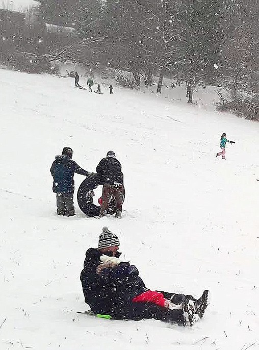 Roger Hance and his three-year-old daughter, Savannah, take a turn down Cherry Hill Monday. One of the lone snowstorms of the winter gave Savannah her first opportunity to go sledding. "She's not totally sure about it," Hance said.