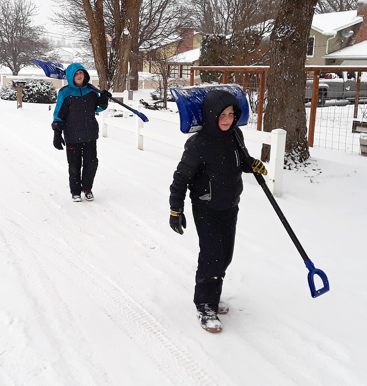 (CRAIG NORTHRUP/Press)
The McFadden brothers — 12-year-old Marcus (left) and nine-year-old Shane — head home after a morning shoveling snow. The Presidents' Day holiday kept schools closed, but kids were out in force Monday to make the most of the snow day.