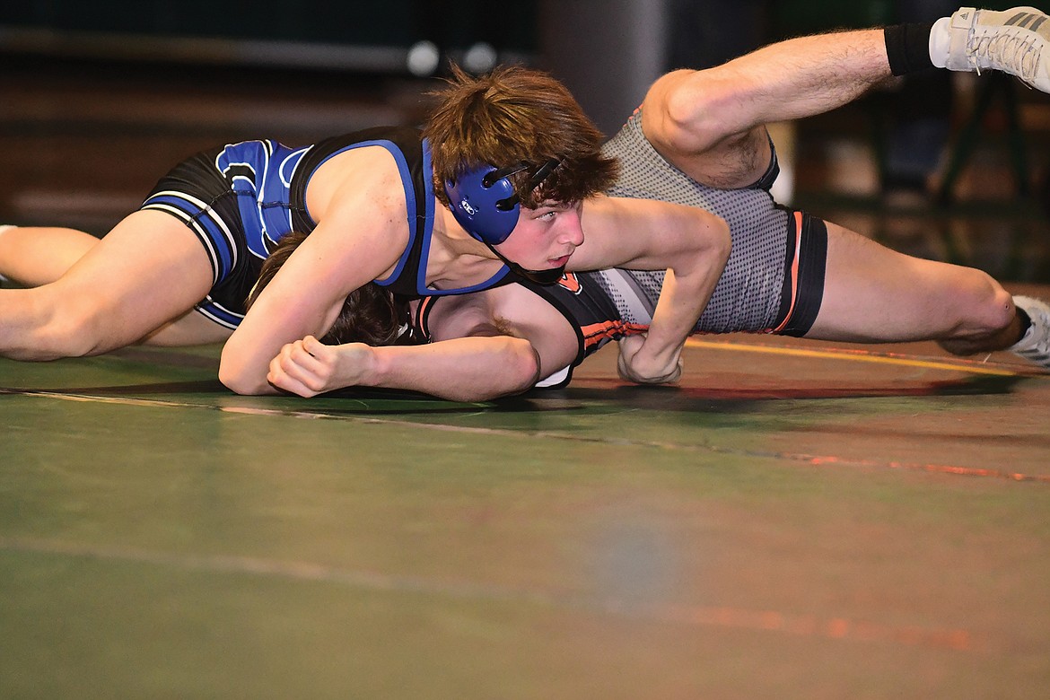 Wildcat Orion Barta goes for the pin against Ronan's Trevor Bartel on Saturday. (Teresa Byrd/Hungry Horse News)