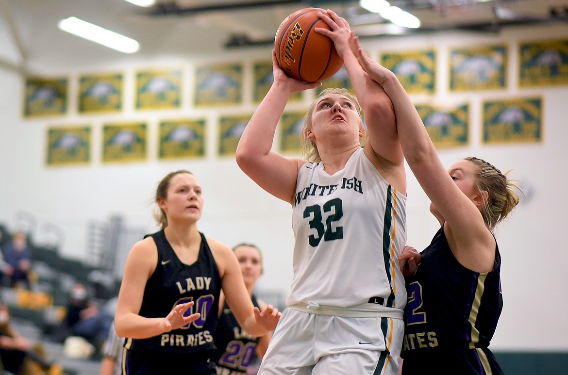 Whitefish senior Brook Smith gets fouled on her way to the hoop against Polson on Thursday. (Whitney England/Whitefish Pilot)