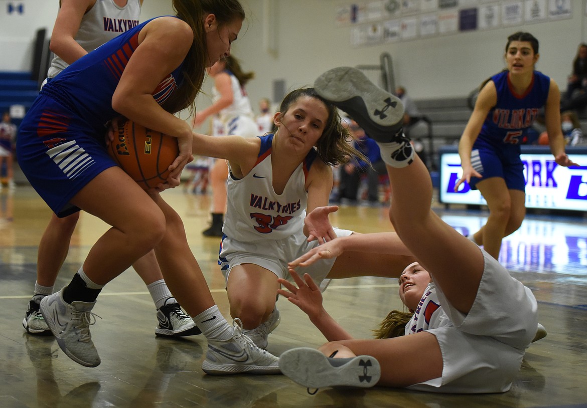 Callie Martinz (middle) and Callie Gambala battle with Columbia Falls guard LaKia Hill for a loose ball last week.
Jeremy Weber/Bigfork Eagle