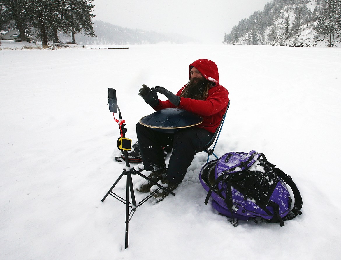 Ethereal in E performs for TikTok followers as he sits on an ice-covered Fernan Lake during a snowfall Tuesday.