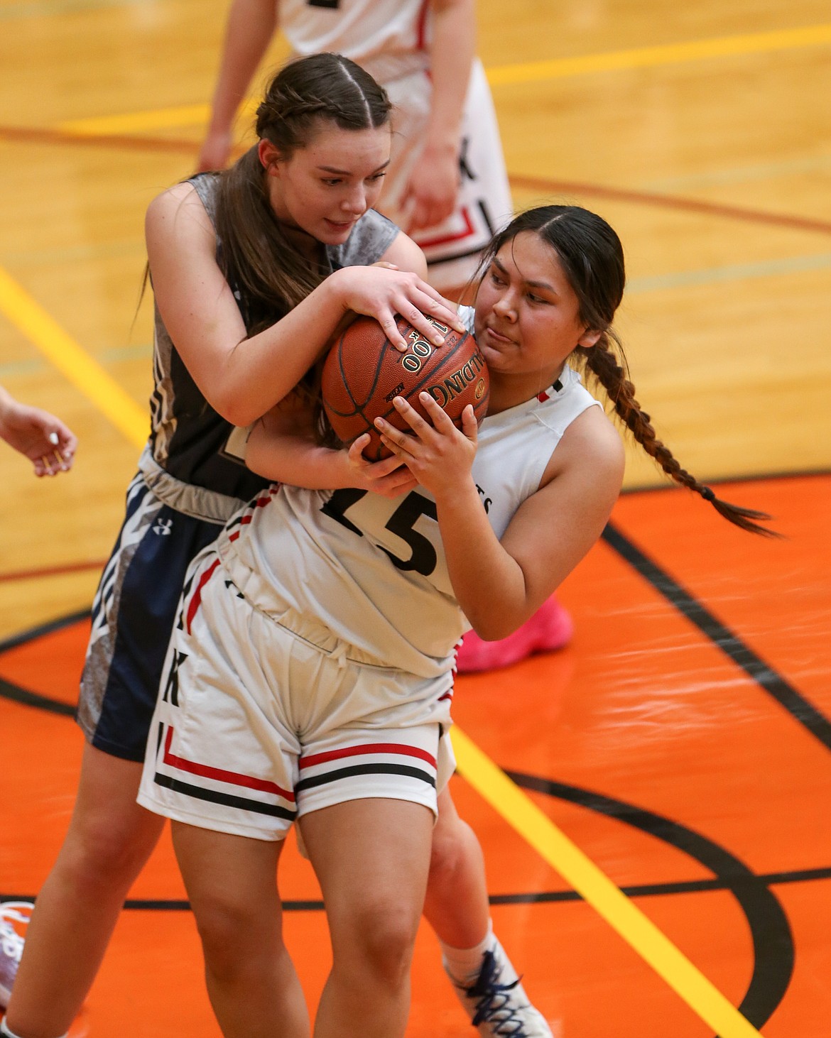 JASON DUCHOW PHOTOGRAPHY
Kria Peters (25) of Lakeside and Kynlee Thornton of Lighthouse Christian wrestle for the ball on Wednesday in a first-round game of the state 1A Division I girls basketball tournament at Columbia High in Nampa.