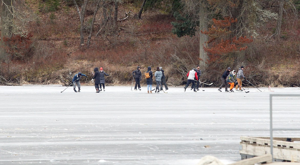 Ice hockey players enjoy a game on the ice covering Fernan Lake on Saturday.