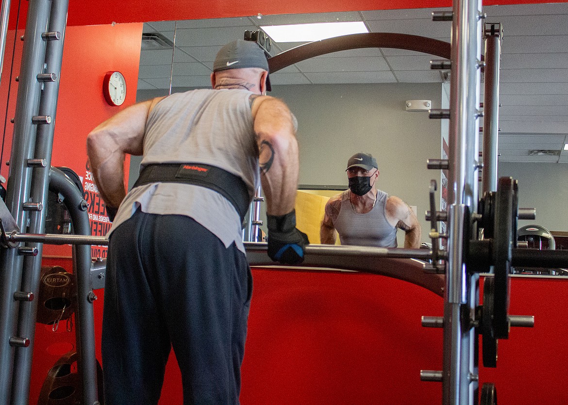 Mike Rapp looks at his reflection as his lifts weights at the Snap Fitness gym in Moses Lake on West Broadway Avenue on Wednesday, Feb. 17.