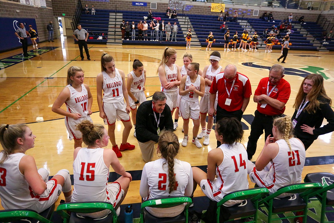 Head coach Will Love talks to the team during a timeout on Thursday.