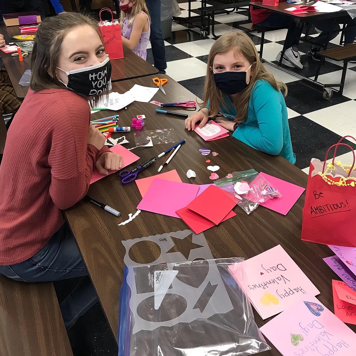 Madison Gunter and a Little Miss make valentines at last week's Be Your Best Self workshop.