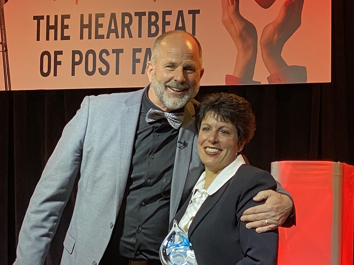 Citizen of the Year Graydon Stanley and Post Falls School District Superintendent Dena Naccarato hug after being awarded the Post Falls Chamber of Commerce's 2020 Organization of the Year. (MADISON HARDY/Press)