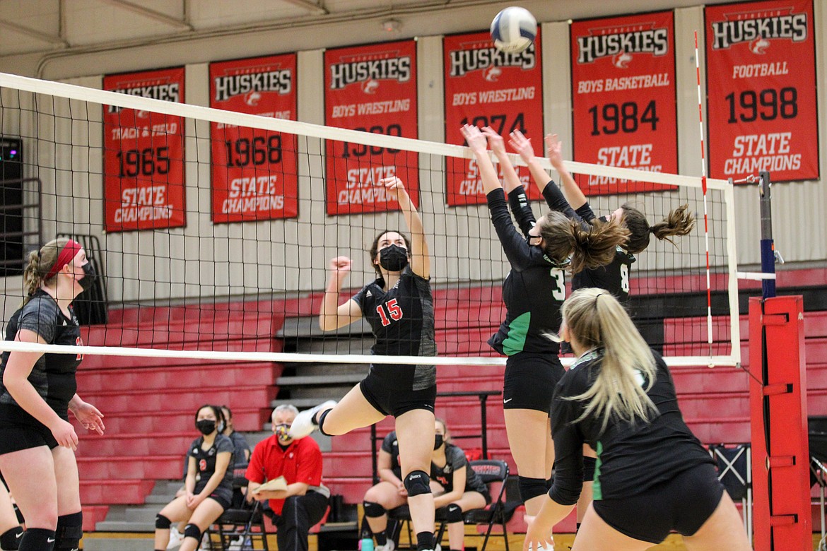 Othello's Natalie Martinez puts the ball just over the East Valley (Spokane) defenders during the first set of the Huskies' 3-0 win over the Knights on Thursday night at Othello High School.