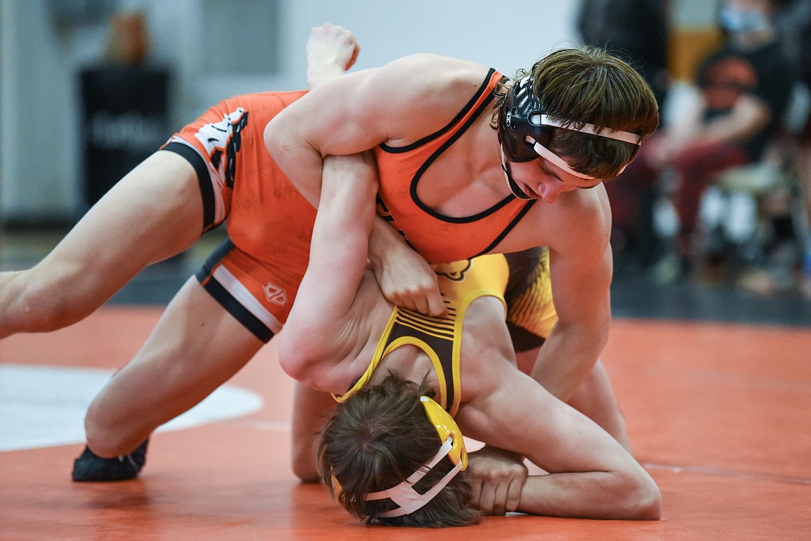 Flathead's Ethan Freund works toward a pin of Helena Capital's Ayden Smelko at 132 lbs. at Flathead High School on Friday. (Casey Kreider/Daily Inter Lake)