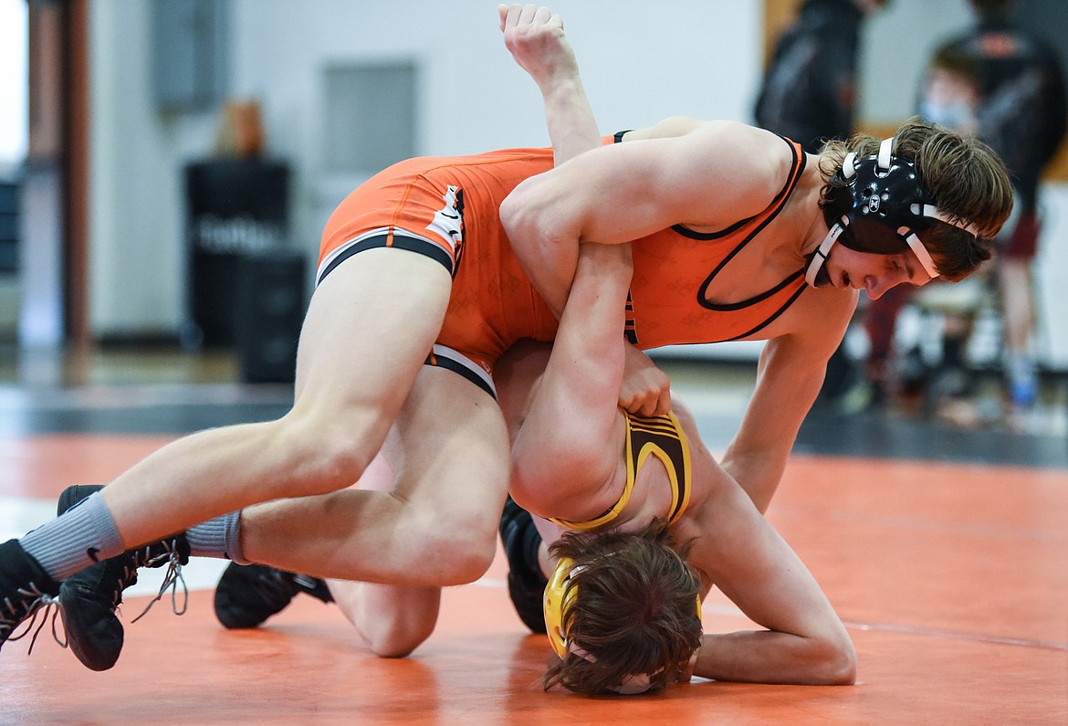 Flathead's Ethan Freund works toward a pin of Helena Capital's Ayden Smelko at 132 lbs. at Flathead High School on Friday. (Casey Kreider/Daily Inter Lake)