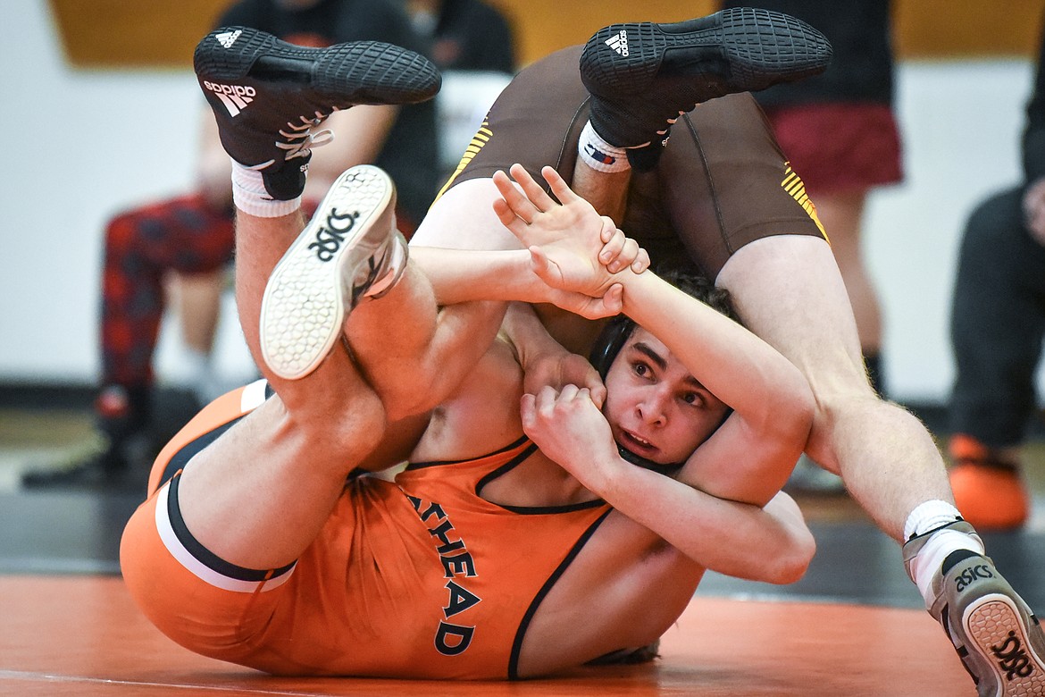 Flathead's Asher Kemppainen looks to escape from Helena Capital's Carson DesRosier at 138 lbs. at Flathead High School on Friday. (Casey Kreider/Daily Inter Lake)