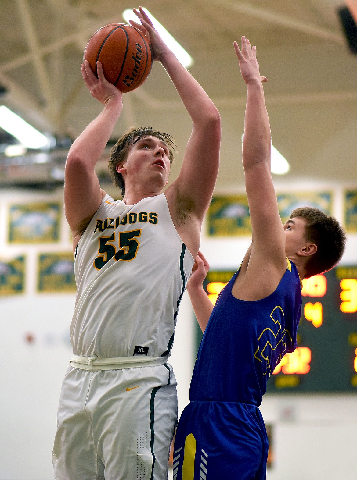 Whitefish junior Talon Holmquist (55) rises up for a shot over Libby's Cy Stevenson in the fourth quarter of a home game against the Loggers on Thursday. (Whitney England/Whitefish Pilot)