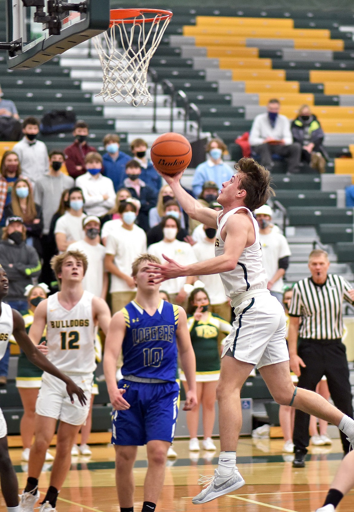 Whitefish's Bodie Smith finds some room in the lane as he looks for a layup against Libby on Thursday. (Whitney England/Whitefish Pilot)