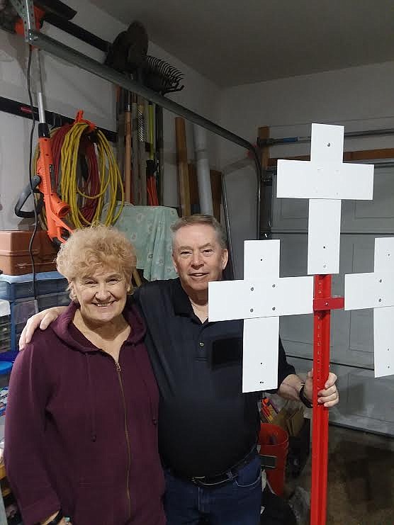 Jim Kelly and his wife, JoAnn, display a sign which will be used to mark where a fatal traffic accident occurred on a Montana highway or road. (Monte Turner/Mineral Independent)