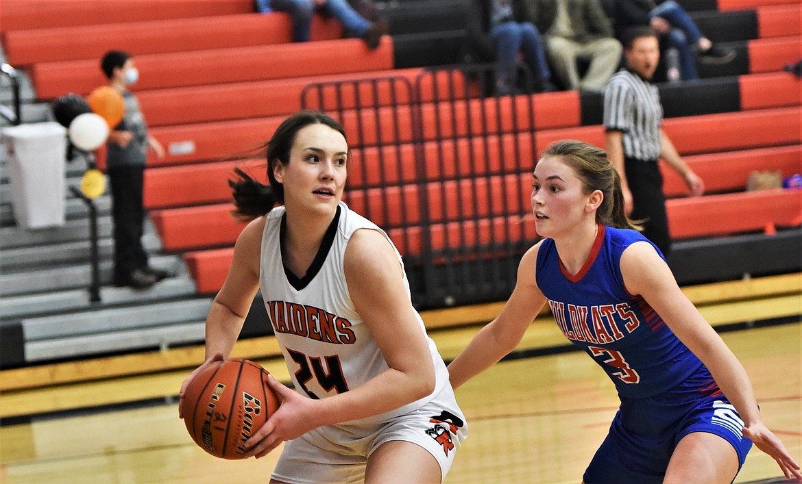 Senior Madeline McCrea pulls down a rebound against Columbia Falls. (Scot Heisel/Lake County Leader)