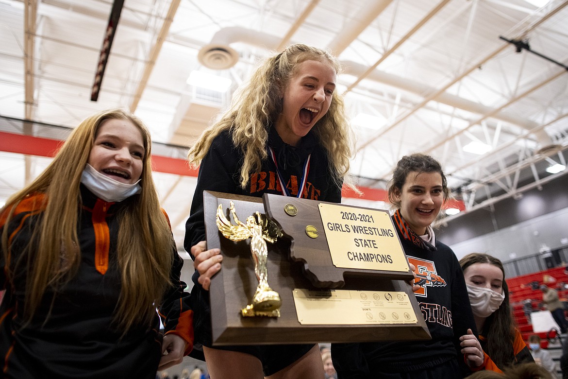Flathead’s Hania Halverson holds the MHSA girls wrestling team state championship trophy after the finals of the MHSA Girl’s Wrestling State Tournament at Lockwood High School in Lockwood on Saturday. (Mike Clark/Billings Gazette)