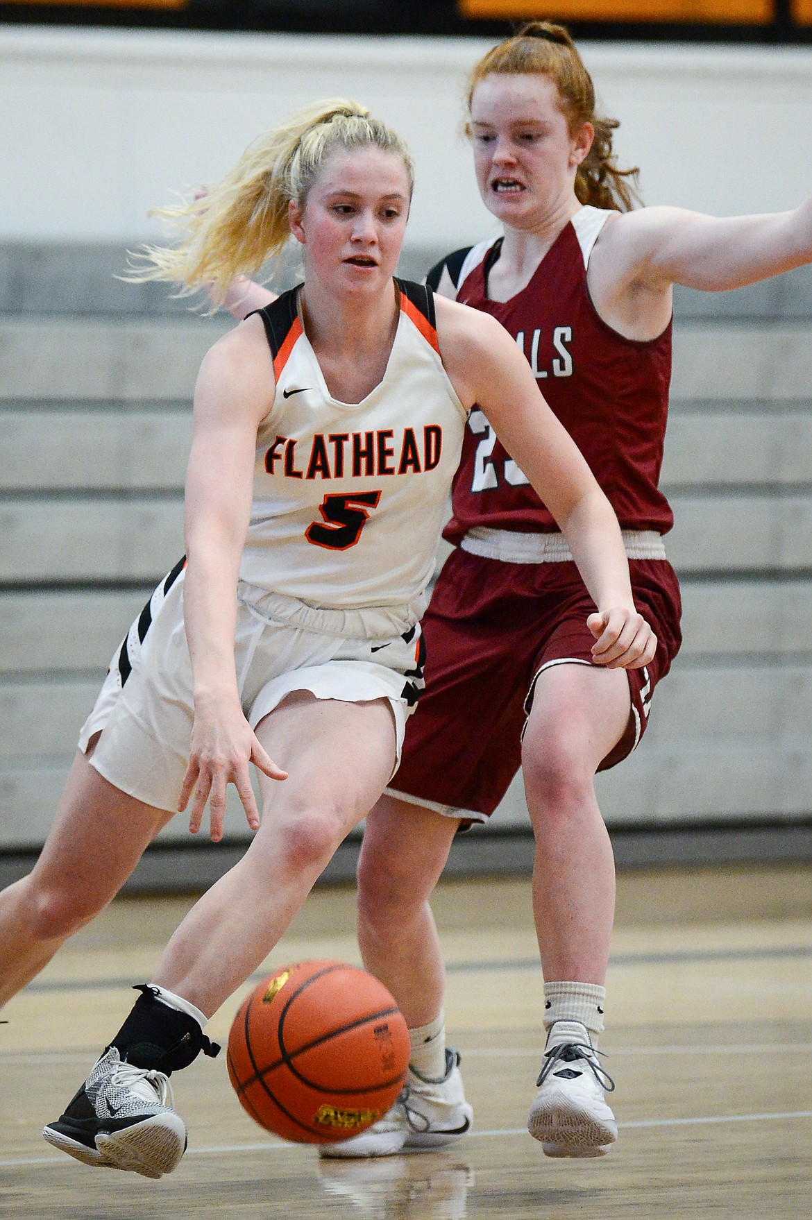 Flathead's Maddy Moy (5) dribbles around Helena High's Kylie Lantz (23) at Flathead High School on Saturday. (Casey Kreider/Daily Inter Lake)