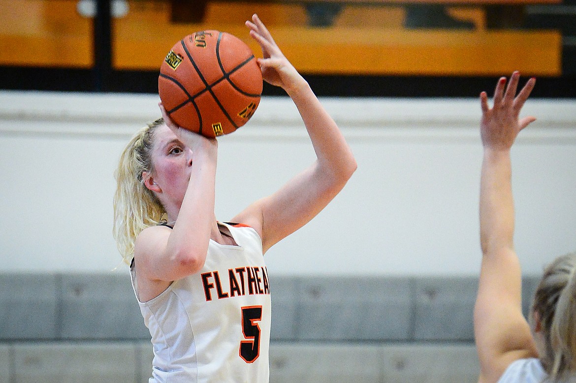Flathead's Maddy Moy (5) spots up for a three-pointer against Helena High at Flathead High School on Saturday. (Casey Kreider/Daily Inter Lake)