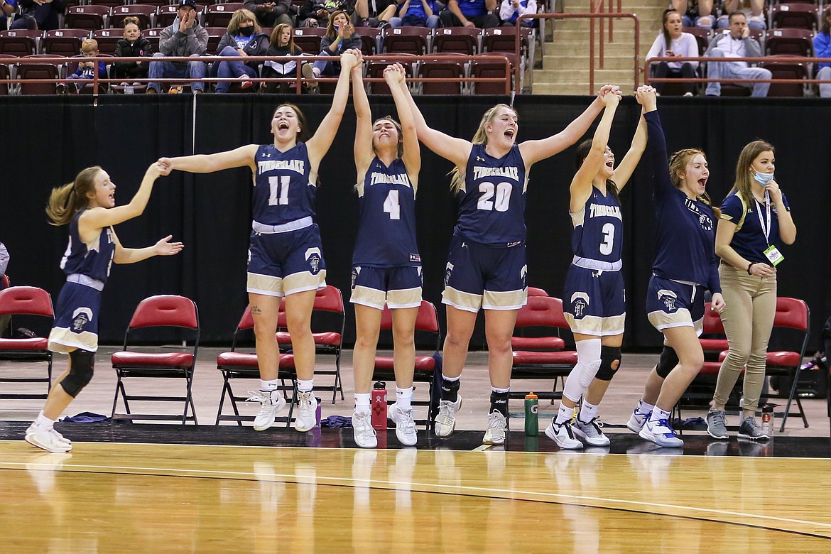 JASON DUCHOW PHOTOGRAPHY
From left, Ciara Soumas, starters Bernie Carhart (11), McKennah Kronenberg (4), Brooke Jessen (20) and Olivia Hammond (3), reserve Morgan Dickinson and assistant coach Jacquelyn Mallet of Timberlake celebrate in the closing seconds as the Tigers won their second straight state 3A girls basketball championship, beating Sugar-Salem in February at the Ford Idaho Center in Nampa.