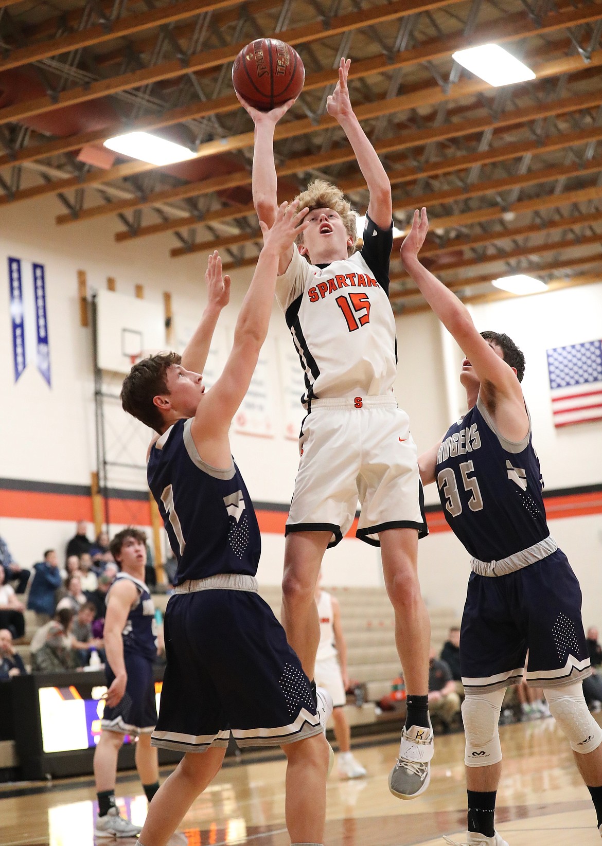 Blake Barrett elevates for a shot over a pair of Bonners Ferry defenders on Saturday.