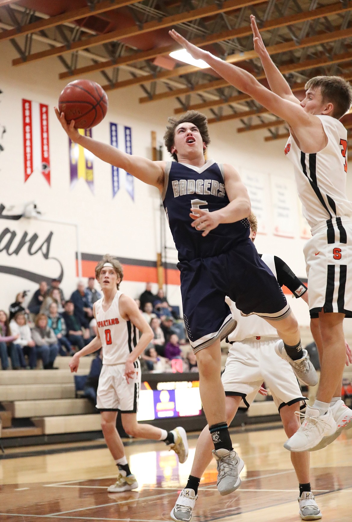 Blake Rice from Bonners Ferry attacks the basket while Priest River's Jordan Nortz defends him on Saturday. Rice hit the game-winning free throw.