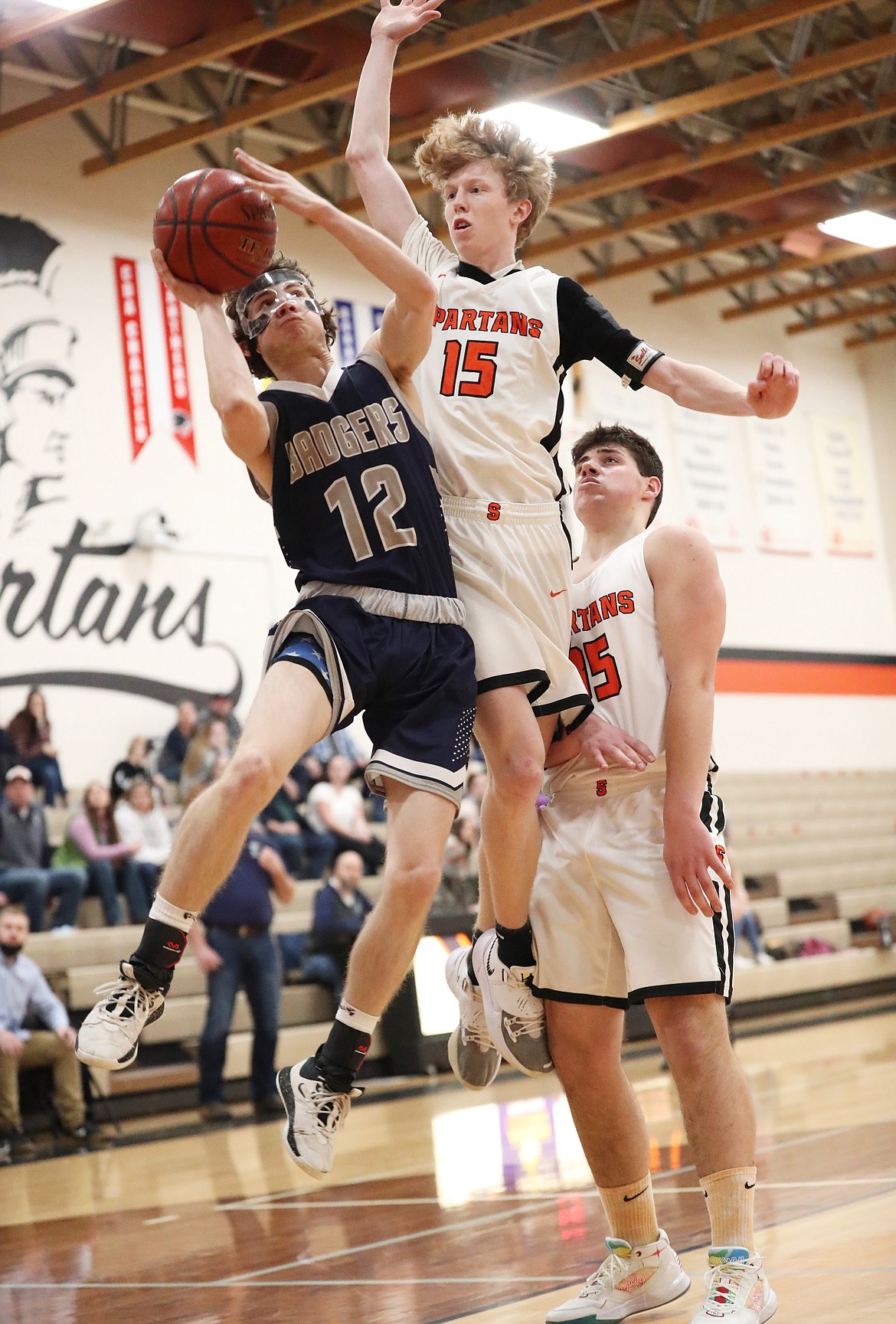 Hayden Stockton from Bonners Ferry attacks the basket and tries to hit a shot while Blake Barrett defends him on Saturday.