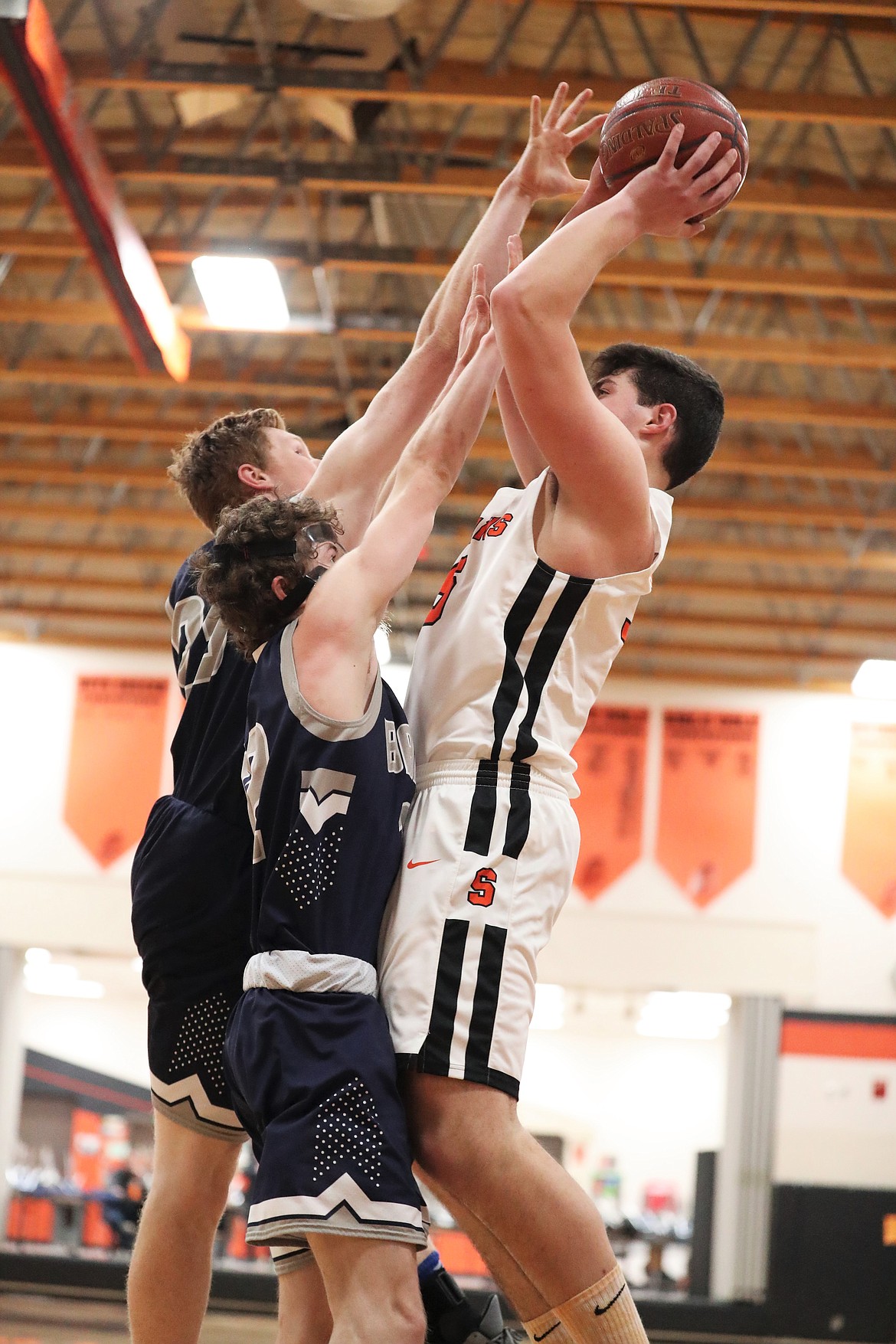 Priest River's Jace Yount attempts a shot over a pair of Bonners Ferry defenders on Saturday.