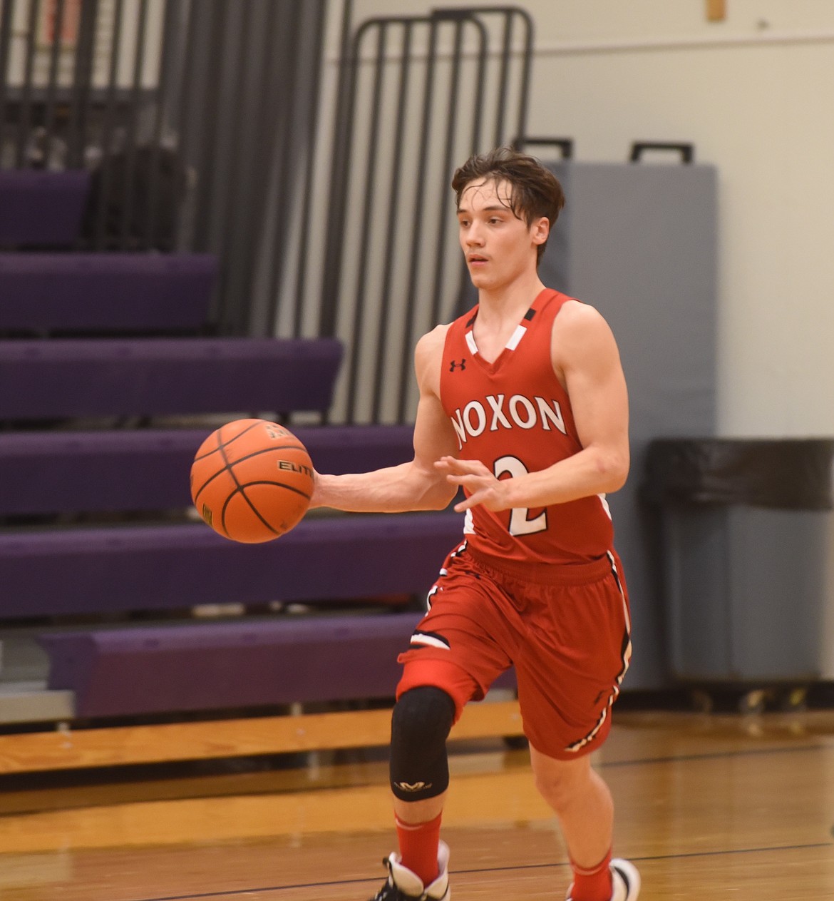 Noxon's Brody Hill heads upcourt against Charlo Friday night. Hill scored 11 points for the Red Devils in a 63-53 loss in the District 14-C playoffs. (Scott Shindledecker/Valley Press)