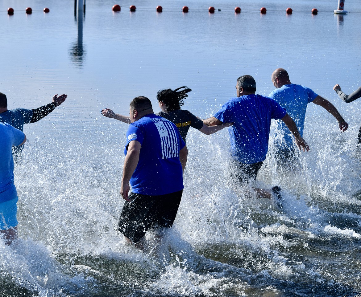 A group of Quincy Police officers take the "polar plunge" on Saturday into the Columbia River at Crescent Bar to raise money for the Special Olympics. QPD officers raised over $4,500 for Special Olympics Washington during the noon event, and the water was cold, according to QPD Chief Kieth Siebert.