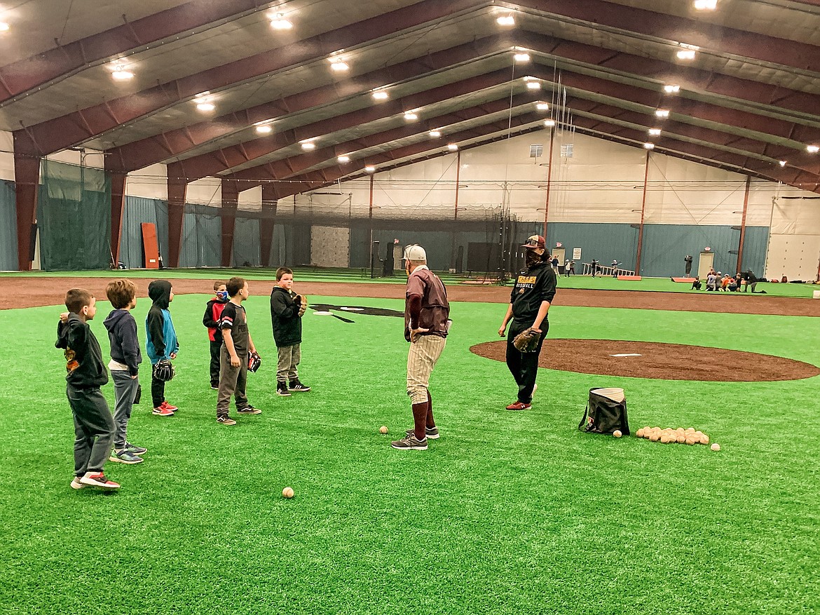 Coach Robert Haensel running an infield drill at the Polar Bear Camp on Saturday.