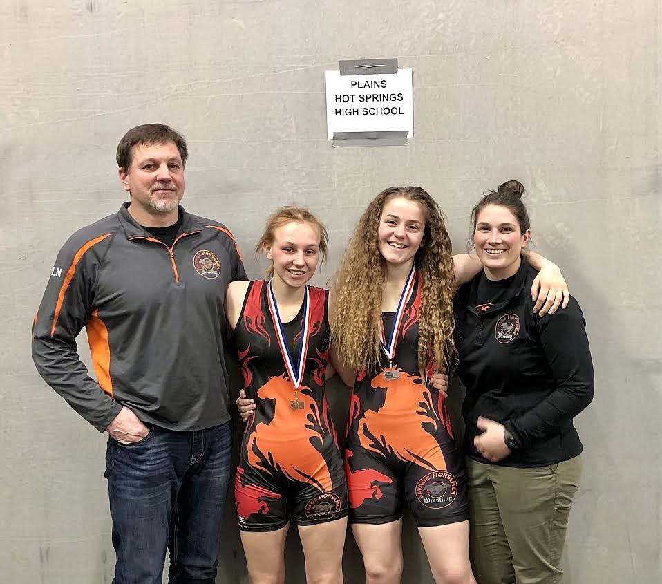 Plains coach Shane Angle, medal winners Taylor Angle (third), Lilly MacDonald (second) and coach Keaton Bannout at the first Montana High School Association all girls state tournament Feb. 20 at Lockwood High School in Billings. (Photo courtesy Shane Angle)