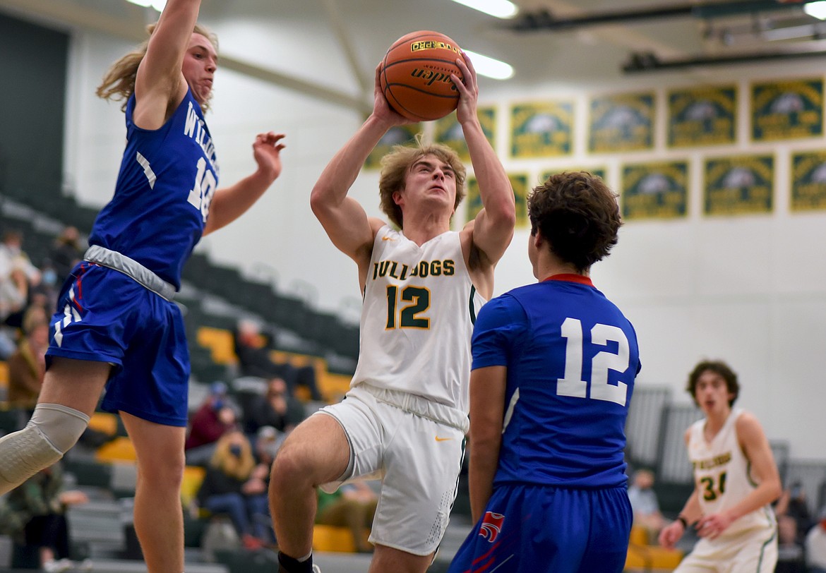 Whitefish junior Logan Conklin makes a move toward the hoop against Columbia Falls in a divisional play-in game Monday night. (Whitney England/Whitefish Pilot)