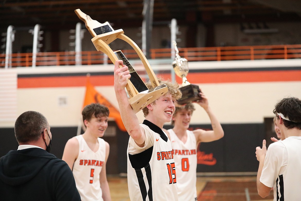 Junior Blake Barrett holds up the league trophy following Tuesday's win.