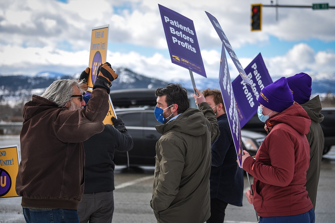 Two members of a group opposing the SEIU Healthcare 1199NW union clash with registered nurses and health care workers from Logan Health gathered to picket along U.S. 93 near Kalispell Regional Medical Center on Tuesday, Feb. 23, 2021. (Casey Kreider/Daily Inter Lake)