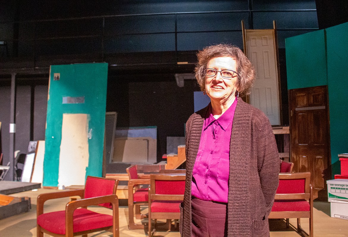 Masquers Theater Artistic Director Cheri Barbre stands on the cluttered stage still filled with set pieces on Monday evening in Soap Lake.