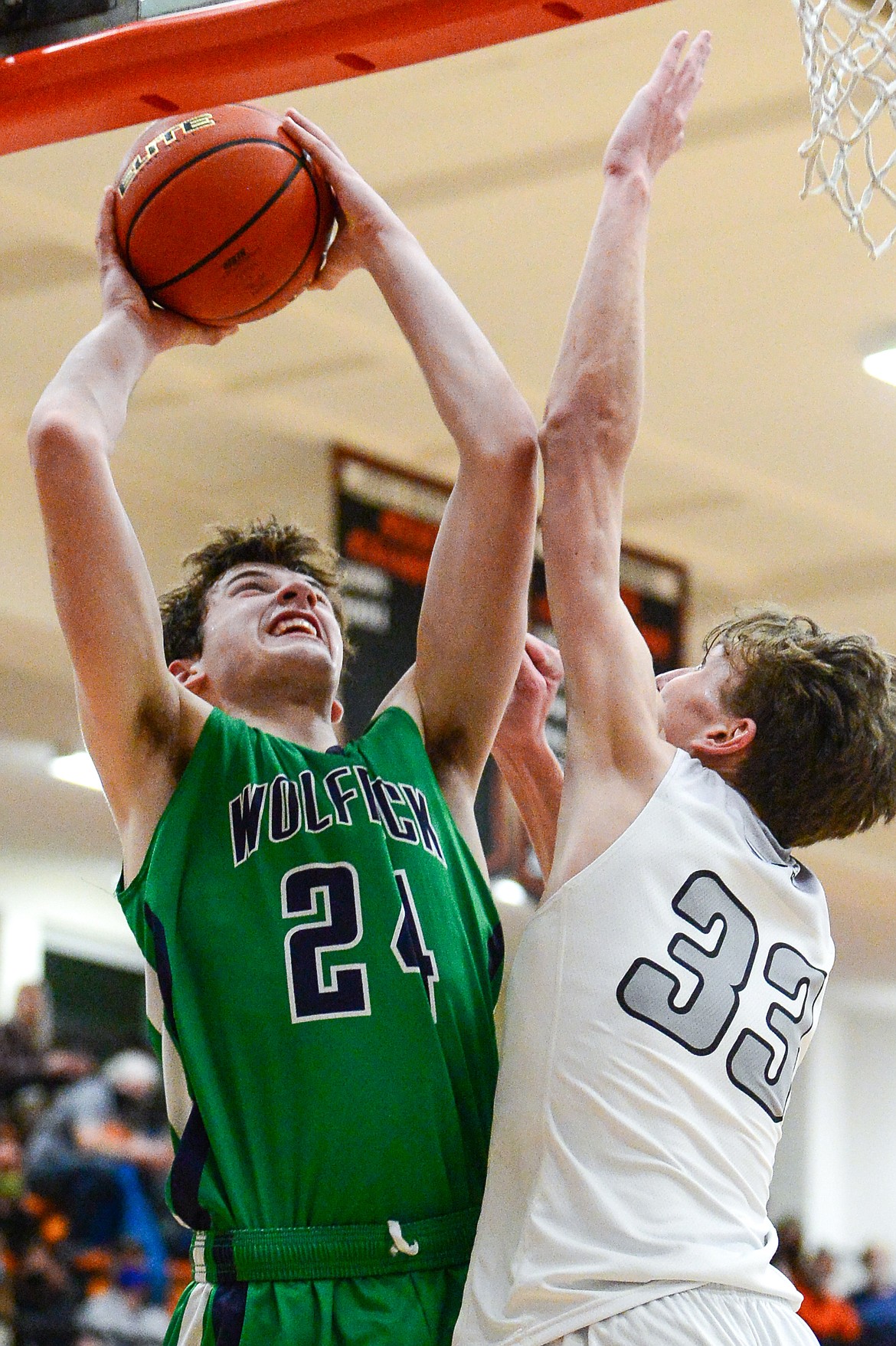 Glacier's Noah Dowler (24) goes to the hoop defended by Flathead's Ezra Epperly (33) at Flathead High School on Tuesday. (Casey Kreider/Daily Inter Lake)