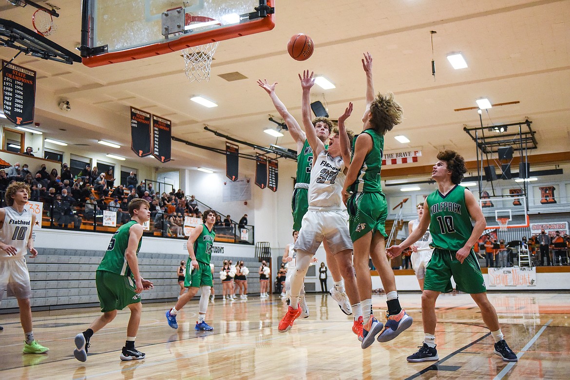 Flathead's Joston Cripe (34) drives to the basket surrounded by Glacier defenders at Flathead High School on Tuesday. (Casey Kreider/Daily Inter Lake)