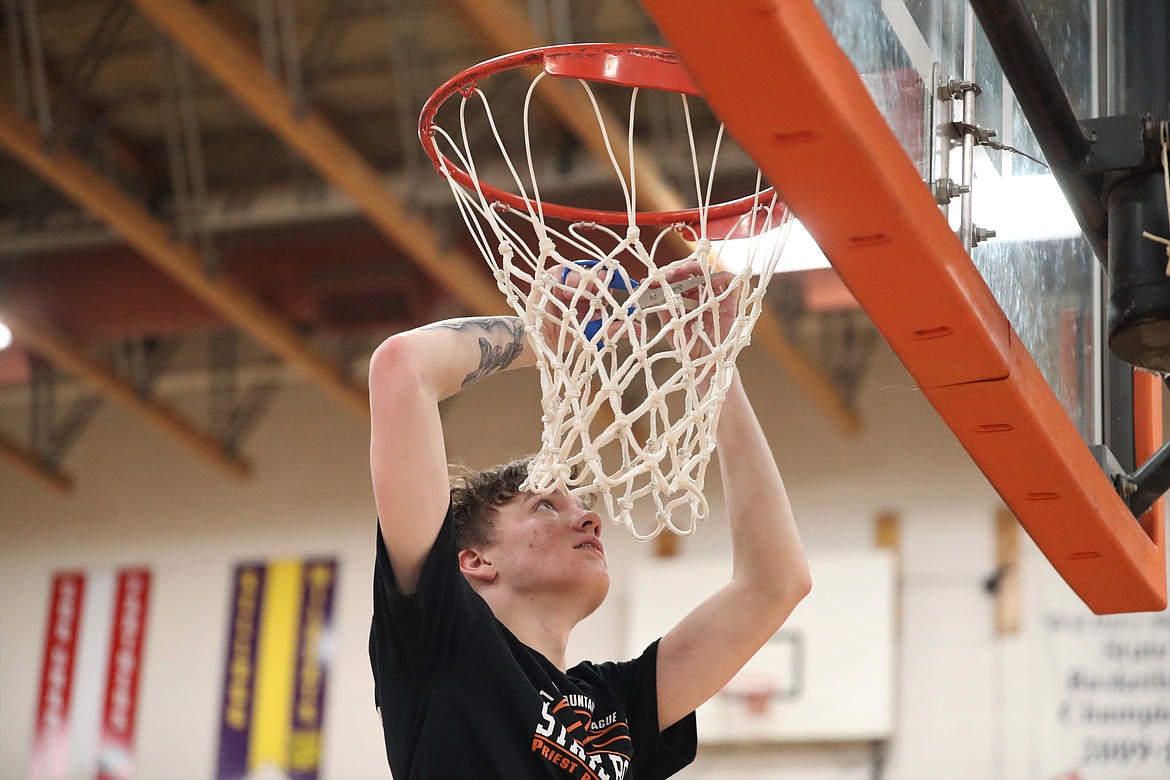 Junior Trentyn Kreager cuts down the nets following Tuesday's district title game against Kellogg.