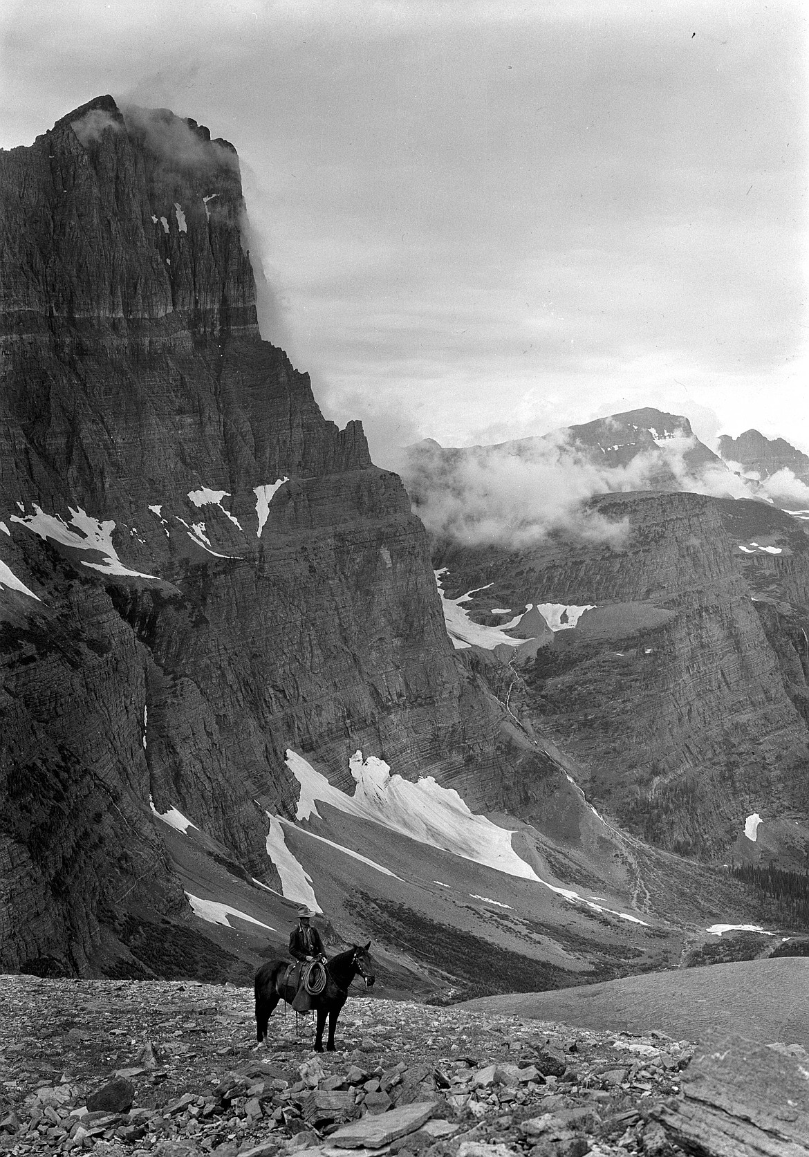 From the chalets, riders would head north over Piegan Pass to the Many Glacier Hotel nearly 13 miles away. This c. 1932 T.J. Hileman photograph shows a lone rider at the pass with Mount Gould on the left. (NPS GLAC103003)
