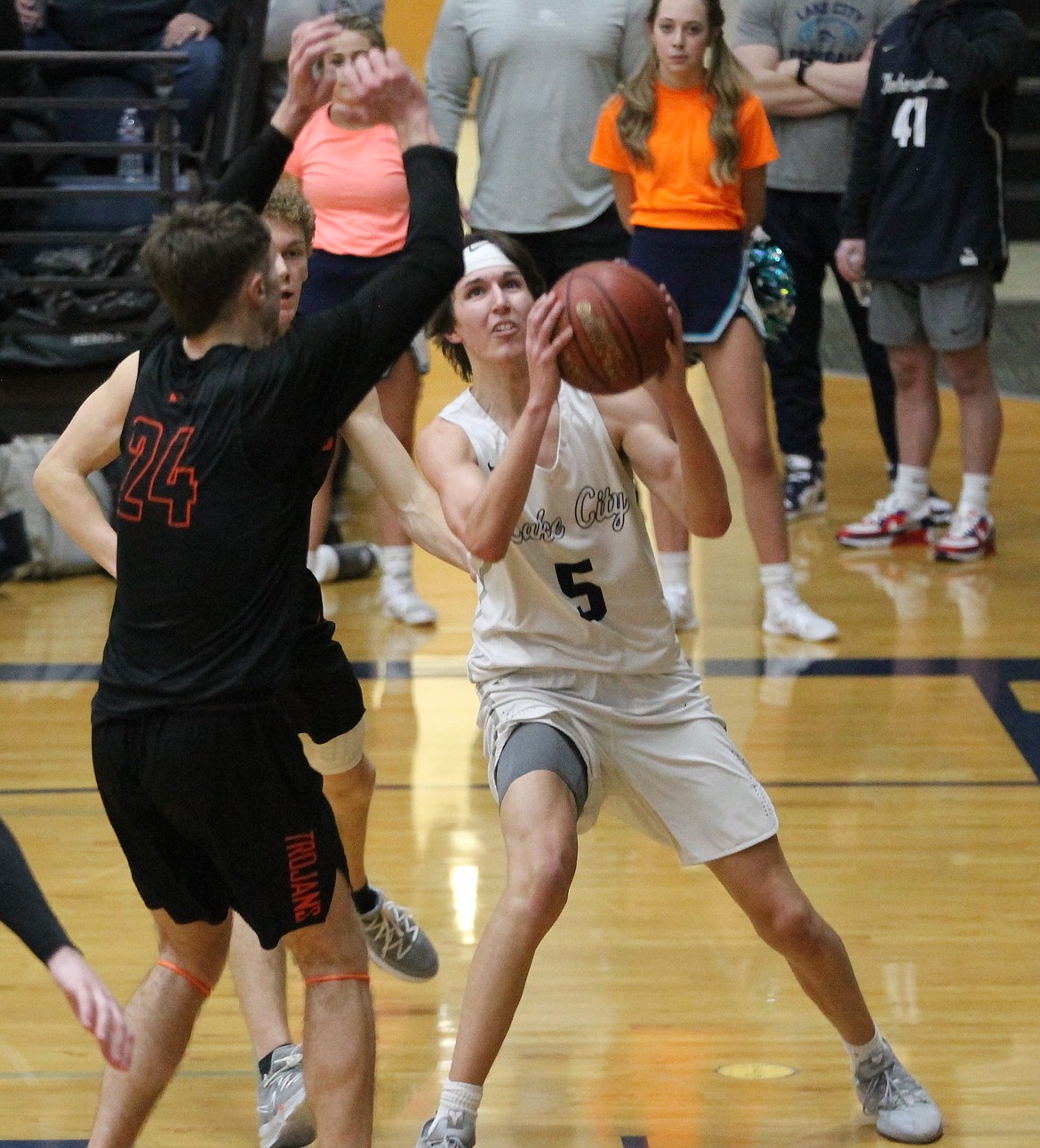 MARK NELKE/Press
Jack Kiesbuy (5) of Lake City goes up for a shot as Alex Horning (24) of Post Falls defends in the first half of Tuesday night's 5A Region 1 boys basketball championship game at Lake City.